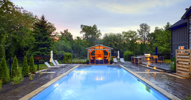 pool with cabana at the far end with a fireplace in it