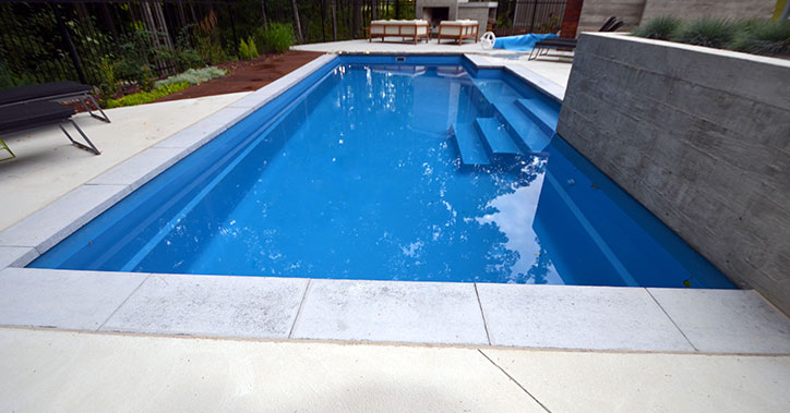 outdoor pool with light concrete surround