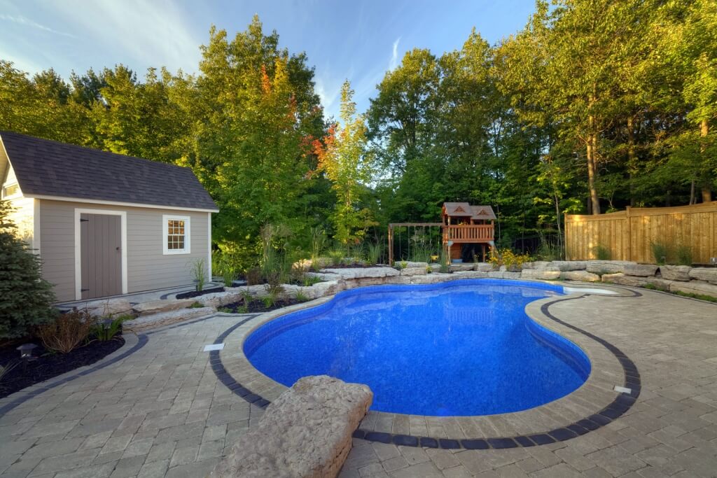 pool with grey brick surround and shed